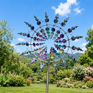May include: A kinetic wind spinner featuring a circular metal frame with multiple radiating arms. Each arm holds a series of iridescent, multi-colored circular discs that shift in hue from blue and green to purple and gold, mounted on a metal pole.