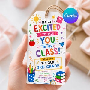 Puede incluir: Una etiqueta de regalo rectangular blanca con un lazo de cuerda marrón que presenta texto colorido que dice I'M SO EXCITED TO HAVE YOU IN MY CLASS! WELCOME TO OUR 3RD GRADE. El diseño incluye ilustraciones de un sol, una manzana, un avión de papel, lápices y libros.