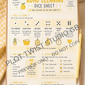 May include: A clipboard holding an ADHD cleaning dice sheet with yellow accents and text. The sheet features sections for rolling dice to determine cleaning tasks, tracking feelings, extra support options, a brain dump area, and a celebration section.