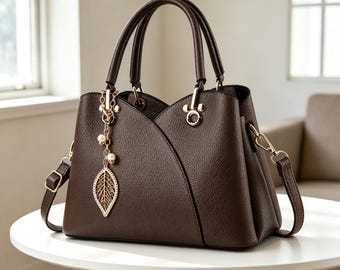 Elegant Faux Leather Satchel Bag with Leaf Charm, Multi-Pocket Shoulder Purse.