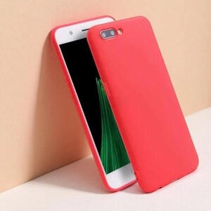 May include: A smartphone featuring a solid bright red protective case covering the back and sides. The device has a white front frame surrounding a black screen, with a visible camera lens and flash cutout on the upper rear of the red case.