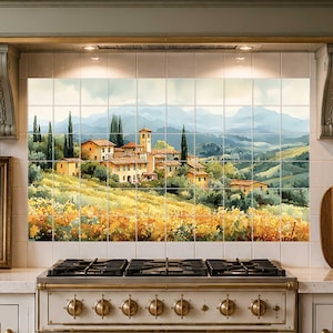 May include: A kitchen backsplash featuring a watercolor painting of a Tuscan landscape. The artwork depicts a village with yellow buildings, cypress trees, and rolling hills. The color palette includes yellows, greens, and blues, creating a warm and inviting atmosphere.