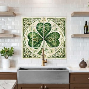 May include: A square wall tile mural featuring a large green shamrock design with intricate Celtic knotwork patterns. The artwork is composed of sixteen individual square tiles arranged in a grid, displaying shades of green and cream.