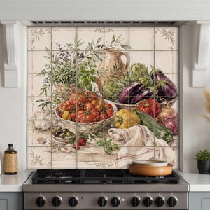 May include: A decorative kitchen backsplash tile mural featuring a watercolor illustration of fresh produce including red tomatoes, purple eggplants, green zucchini, yellow peppers, and herbs in ceramic bowls on a light cream background.