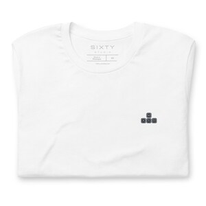 May include: A white t-shirt featuring a small embroidered graphic on the chest of four dark gray computer keyboard keys labeled W, A, S, and D. The inner neck label displays the text SIXTY STUDIO, Made in Nicaragua, XS, and 100% cotton.