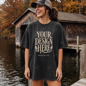 May include: A charcoal gray short-sleeve t-shirt featuring the beige text "YOUR DESIGN HERE" in a stylized serif font, accented with leaf illustrations and the smaller text "Mocks by Issy" printed below the main design on the front of the shirt.