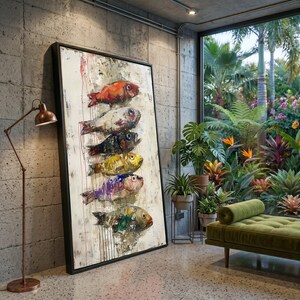 May include: A large rectangular framed wall art piece featuring a vertical stack of six stylised fish painted in vibrant red, white, black, yellow, purple, and green tones against a textured off-white background with visible paint drips.