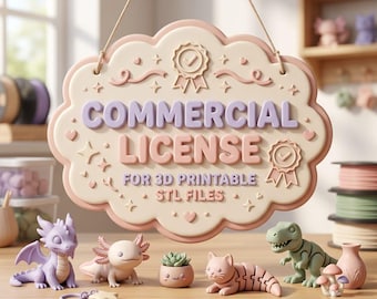 May include: A hanging cloud-shaped sign with the text COMMERCIAL LICENSE FOR 3D PRINTABLE STL FILES in purple and pink, featuring two award ribbon icons. Below are small 3D printed figures including a purple dragon, axolotl, cat, and dinosaur.