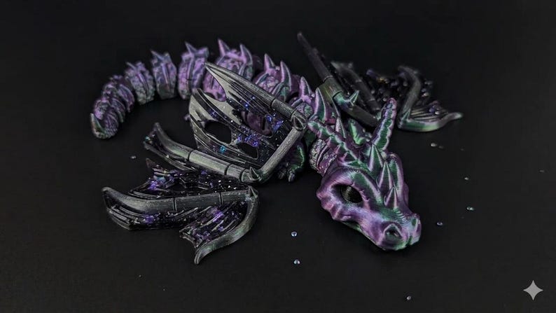 May include: A detailed, articulated dragon figurine in shades of purple, black, and green. The dragon is posed on a dark surface, with its head, wings, and segmented body clearly visible. The design features intricate details and a fantasy theme.