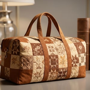 May include: A brown and tan quilted duffel bag with a patchwork design. The bag has two handles and a zipper closure. The bag is approximately 18 inches long, 10 inches high, and 10 inches wide.