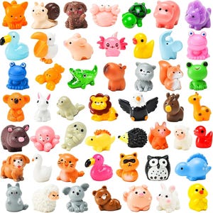 May include: A collection of forty-eight miniature animal figurines in various colors and species, including a cat, snail, dog, crab, turtle, hippo, dinosaur, bird, pig, axolotl, duck, elephant, frog, lobster, crocodile, capybara, squirrel, koala, seal, lion, eagle, giraffe, hedgehog, fox, sheep, owl, and raccoon.