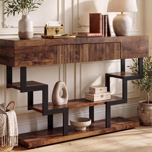 May include: A rectangular wooden console table with a dark brown wood grain finish, featuring a central fluted drawer and a black metal frame. The structure includes multiple staggered open shelves, a flat top surface, and a sturdy base for storage.