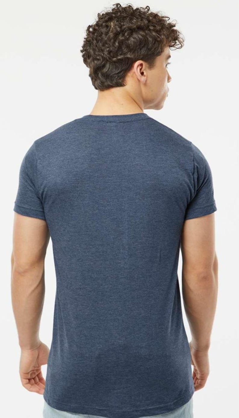 May include: A short-sleeved, navy blue t-shirt. The back view shows the shirt's crew neck and the texture of the fabric. The shirt is a solid color and appears to be made of a soft material.