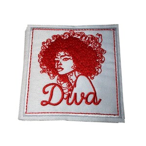 May include: Square white patch with a red embroidered design. The design features a woman's profile with curly hair and the word "Diva" in cursive. The patch has a white border with a gray trim.
