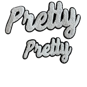May include: Two white, fluffy "Pretty" patches with a black border. The word is written in a cursive, playful font. The patches are in two sizes, one large and one small, and are set against a white background.