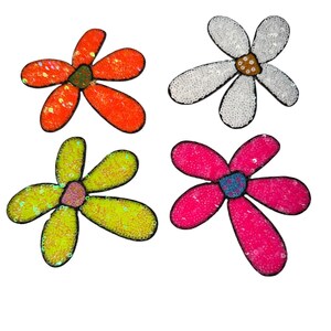 May include: Four colorful sequined flower patches. The flowers are in shades of orange, white, yellow-green, and pink, each with a contrasting center. The patches are likely for decorative use on clothing or accessories.