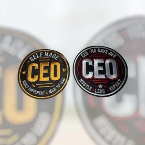 May include: Two round embroidered patches with the word "CEO". One is black and gold with the text "Self Made, Built Different, Made to Lead". The other is black and red with "No Days Off, Hustle, Lead, Repeat".