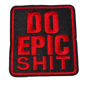 May include: A square black patch with a red border and the words "DO EPIC SHIT" embroidered in red. The patch has a textured appearance.