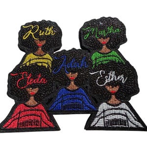 May include: Embroidered patches depicting women with afros. Each patch has a different name embroidered in a cursive font: Ruth, Martha, Electa, Adah, and Esther. The women are wearing tops in various colours: yellow, green, red, blue, and white.