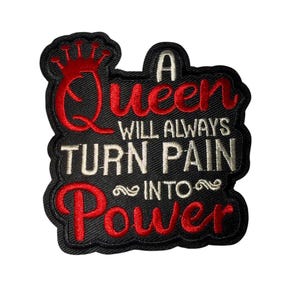 May include: Black embroidered patch with the text "A Queen Will Always Turn Pain Into Power" in red and white. The patch features a red crown design above the word "Queen".