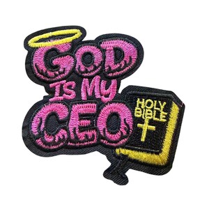 May include: An embroidered patch featuring the text "GOD IS MY CEO" in pink bubble letters with a yellow halo above the word "GOD". To the right, a black book with yellow edges and a yellow cross is labeled "HOLY BIBLE" in yellow text.