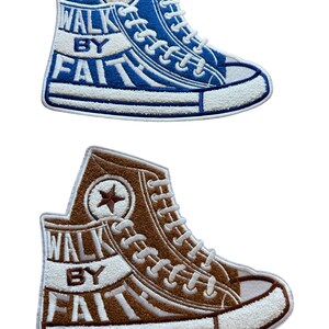May include: Two embroidered patches in the shape of high-top sneakers. One is blue with white accents and the text "WALK BY FAITH." The other is brown with white accents and the same text. Each patch features a star.