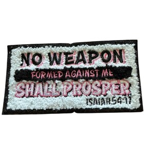 May include: A rectangular embroidered patch with a white textured background and a black border. The text reads NO WEAPON in black, FORMED AGAINST ME in pink, and SHALL PROSPER in pink, with ISAIAH 54:17 in black at the bottom right corner.