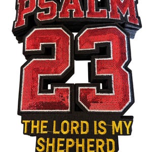 May include: A stack of embroidered patches with the text "PSALM 23" in red sequins and black borders. Below, the text "THE LORD IS MY SHEPHERD" is in yellow thread. The patches are likely for clothing or accessories.