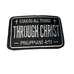May include: Black rectangular patch with white embroidered text. The text reads "+ I CAN DO ALL THINGS + THROUGH CHRIST - PHILIPPIANS 4:13 -" with a white border. The patch has a textured appearance.