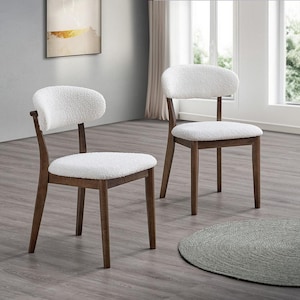 May include: Two wooden chairs with a curved back and seat, featuring a white, textured fabric. The chairs have a dark brown wooden frame and legs. The chairs are placed in a well-lit room with a neutral color palette.