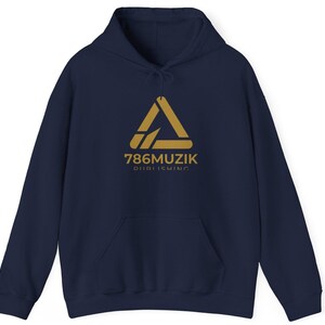 May include: A navy blue hooded sweatshirt featuring a gold-colored triangular logo and the text 786MUZIK PUBLISHING printed on the chest. The garment includes a front kangaroo pocket, long sleeves with ribbed cuffs, and a matching drawstring hood.