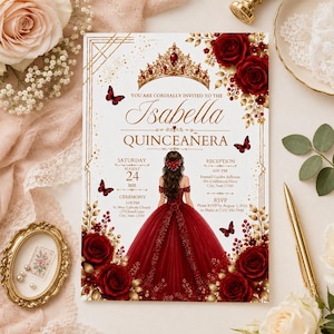 May include: A rectangular Quinceañera invitation card featuring a gold crown, red roses, and butterflies. The text reads: You are cordially invited to the Isabella Quinceañera, Saturday August 24 2025, Ceremony 3:00 PM St. Mary Catholic Church, Reception 6:00 PM.