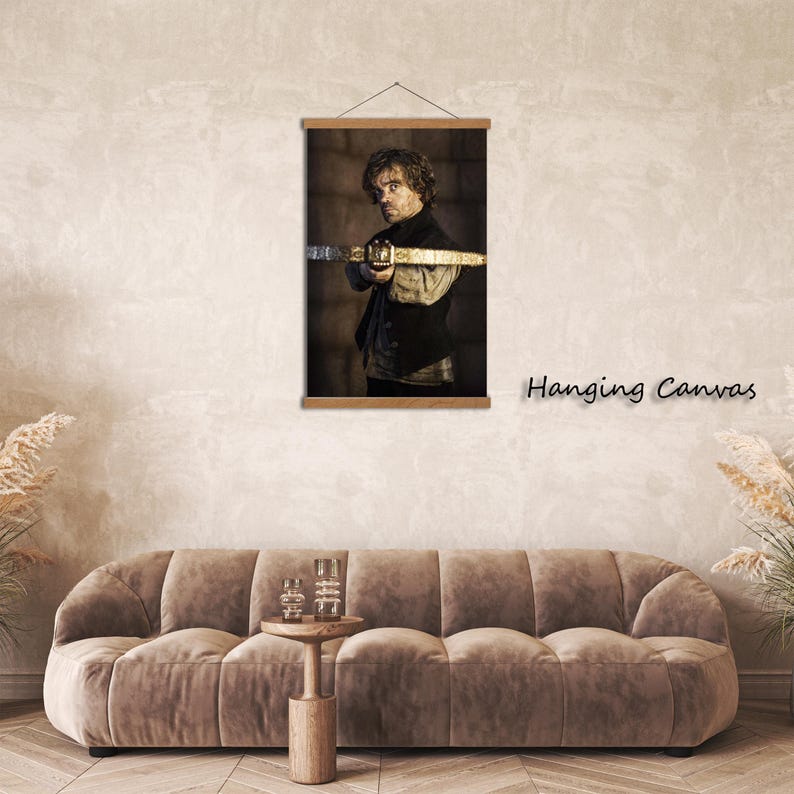 May include: Hanging canvas print featuring a portrait of a man holding a sword. The artwork is displayed on a wooden frame and is suspended from a black cord. The text "Hanging Canvas" is printed in black on the right side of the image.