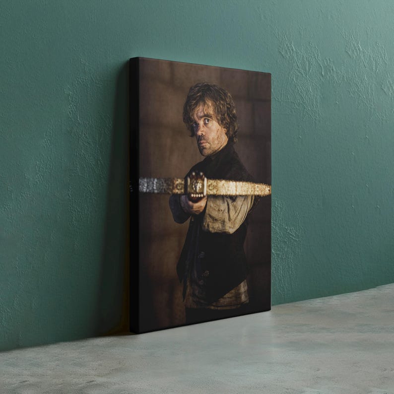 May include: A canvas print featuring a portrait of a man holding a crossbow. The man is wearing a dark vest over a light-colored shirt. The background is a blurred, sepia-toned interior.