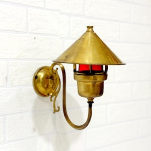 Rustic Brass Wall Sconce with Decorative Shade Cap and Red Glass | Vintage Bulkhead Lighting