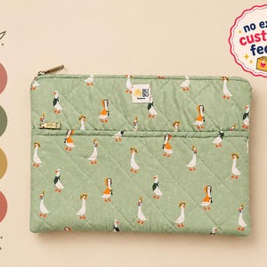 May include: A sage green quilted laptop sleeve featuring a repeating pattern of white and orange geese wearing various accessories. The rectangular case has a gold zipper closure, a small BUBU brand tag, and is available in 13, 14, 15, and 16 inch sizes.