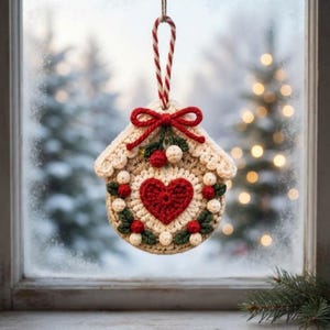 May include: A round, crocheted ornament featuring a central red heart surrounded by cream-colored yarn, green leaves, and small red berries. A red yarn bow sits at the top, attached to a red and white striped hanging loop for display.