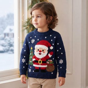 May include: A navy blue long-sleeve knit jumper featuring a central graphic of Santa Claus, a green Christmas tree, and a brown sack of gifts. The jumper is decorated with white snowflake patterns and has a ribbed crew neckline and cuffs.