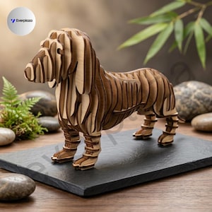 May include: A three-dimensional dachshund sculpture constructed from layered light brown wood pieces. The dog figure features a segmented, ribbed design with visible stacked panels forming the head, body, and legs, standing on a flat rectangular base.