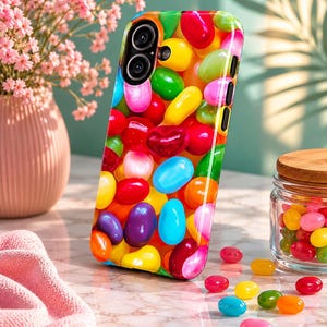 May include: A smartphone case featuring a vibrant, glossy pattern of multi-colored jelly beans in shades of red, yellow, green, blue, orange, pink, and purple. The case has cutouts for a dual-lens camera system and side buttons on the right edge.