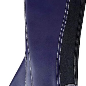 May include: A dark blue equestrian half chap featuring a smooth finish, white contrast stitching along the seams, and a black elasticated side panel. The gear includes a vertical zipper closure, a bottom stirrup strap, and a small hook-and-loop tab.