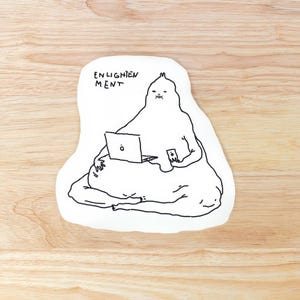 以下が含まれることがあります： ラップトップとスマートフォンを使用している、黒い線画の塊のような人物が描かれた、白いクッション。テキスト「ENLIGHTENMENT」がその人物の上にあります。
