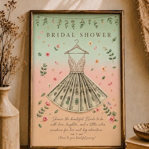 Könnte beinhalten: Gerahmter Kunstdruck "Bridal Shower". Das Kunstwerk zeigt ein Kleid aus Geldscheinen, das an einem Kleiderbügel hängt, mit floralen und botanischen Akzenten. Der Text lautet: "Shower the beautiful Bride-to-be with love, laughter, and a little extra sunshine for her next big adventure."