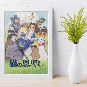 May include: A framed print featuring a colorful anime illustration with various anthropomorphic cats. The artwork showcases a group of cats in different outfits and poses, with Japanese text at the bottom. The frame is white, and the print is displayed on a white wall.