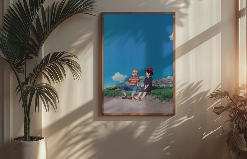 May include: A framed art print featuring an anime-style illustration of two characters sitting on a grassy hill under a blue sky with clouds. One character wears a red and brown striped shirt, the other a black dress and red bow.