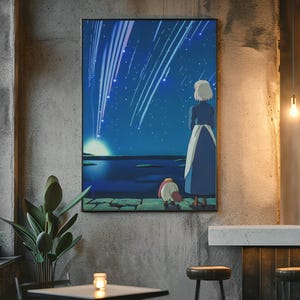 May include: A rectangular wall art print featuring an animated scene of a person with short white hair in a long blue dress and a small creature standing on a stone ledge, looking out at a dark blue night sky filled with bright falling stars.