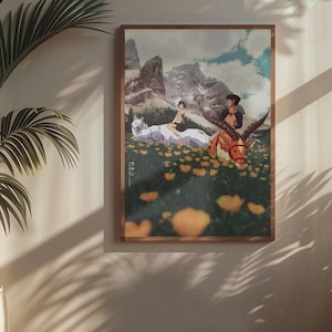 May include: A framed art print with an anime-style illustration. The artwork shows two figures riding fantastical creatures in a field of yellow flowers, with mountains in the background. The print is displayed on a wall with a potted plant.