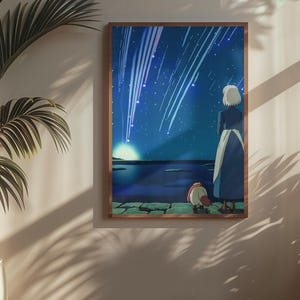 May include: A rectangular framed wall art print featuring an animated illustration of a person with short white hair and a small creature standing on a stone ledge, looking out at a dark blue night sky filled with bright white streaks of falling stars.