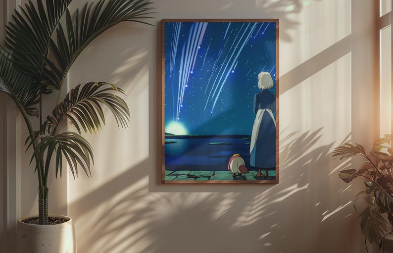 May include: A rectangular framed wall art print featuring an animated illustration of a person with short white hair and a small creature standing on a stone ledge, looking out at a dark blue night sky filled with bright white streaks of falling stars.