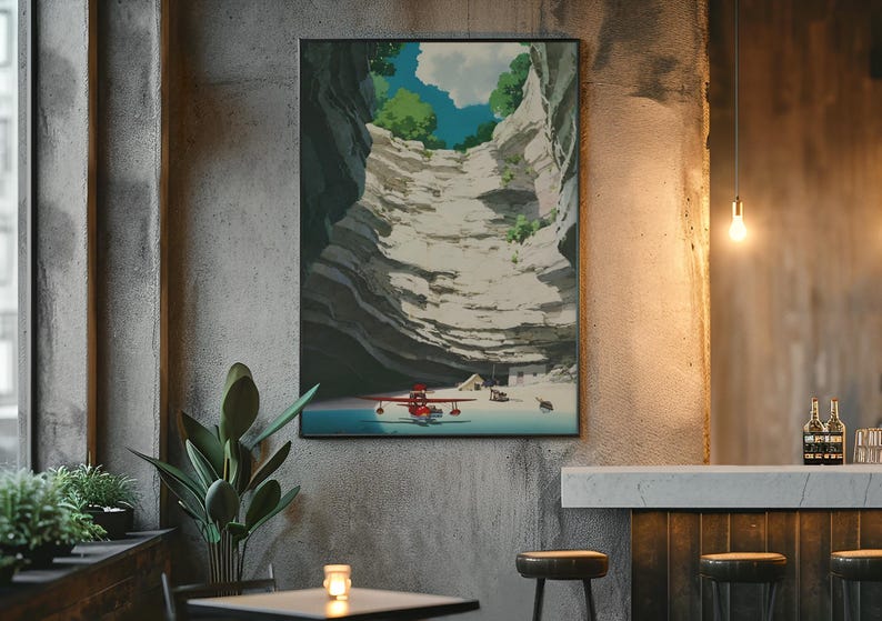 May include: A framed art print depicts a canyon scene with a red seaplane on the water. The artwork features a blue sky with clouds, green trees, and a white cliff face. The print is displayed on a textured gray wall.